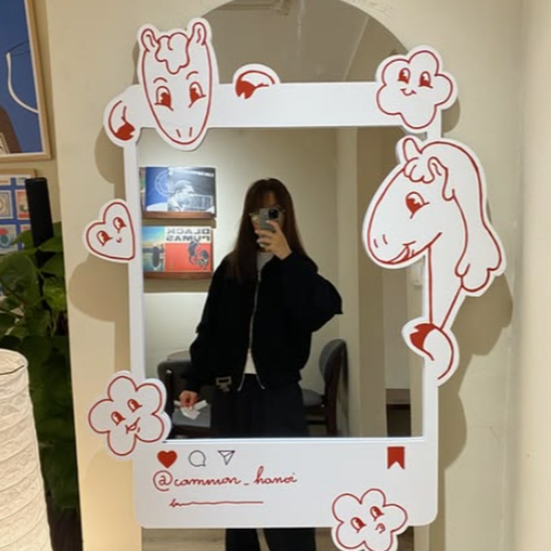 Doodle-frame mirror in a hallway